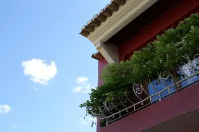 a balcony with plants on the side of a building at Quinta dos Amigos in Almancil