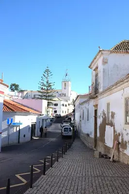 a cobblestone street in a town with buildings at Casas Barulho Apartment Old Town in Albufeira