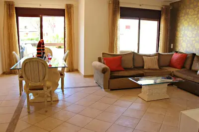 a living room with a couch and a table at Vilamoura Typical 3 With Pool by Homing in Quarteira
