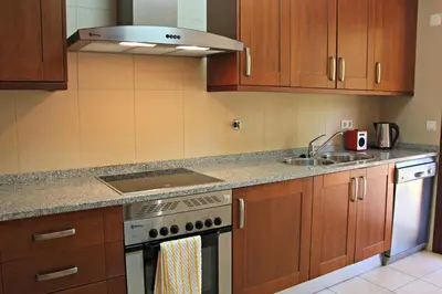 a kitchen with a stove and a sink at Vilamoura Typical 3 With Pool by Homing in Quarteira