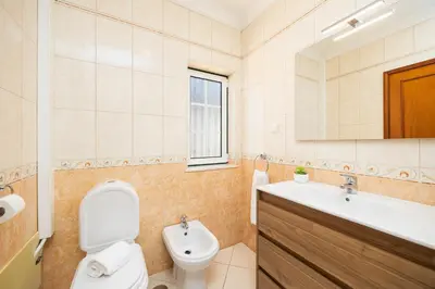 a kitchen and dining room with a wooden table and chairs at Villa Santa Maria in Albufeira