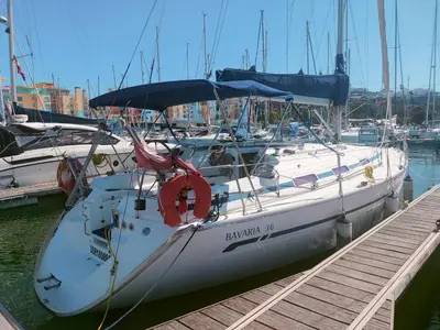 a white boat is docked at a dock at Alma in Albufeira