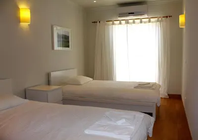 a bedroom with two beds and a window at Fantastic view over the sea in Albufeira