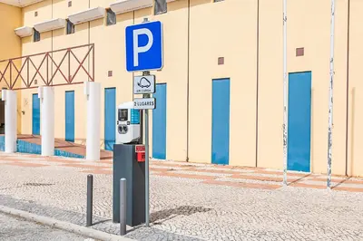 a hospital room with two beds and a chair at HI Faro – Pousada de Juventude in Faro