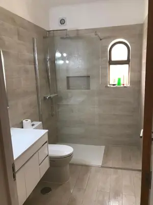 a bathroom with a shower and a toilet and a sink at 4 Bedroom Villa with Heated Pool close to Old Village in Vilamoura