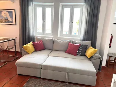 a living room with a couch with colorful pillows at Villa 2BDR with sea view, private pool in Albufeira