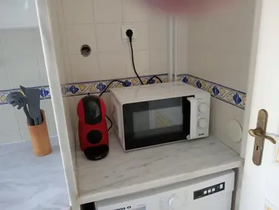 a microwave sitting on top of a counter in a kitchen at Albufeira INN - Mulatinho V2 in Olhos de Água