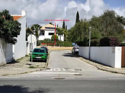 a green car parked on the side of a street at Albufeira INN - Mulatinho V3 in Olhos de Água