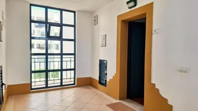 a hallway with a door and a large window at Apartamento Olhos do Mar in Olhos de Água