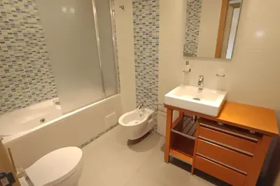 a bathroom with a sink and a toilet and a shower at Parque Atlântico Modern Seaview Apartment with Pool and Tennis Court in Cavacos