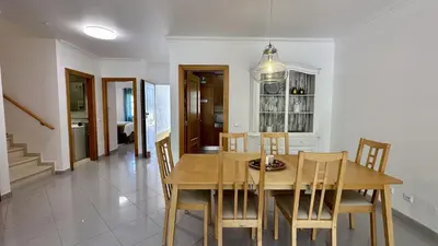 a dining room with a wooden table and chairs at Pine Cliffs by Check-in Portugal in Albufeira