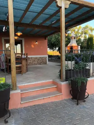 a patio with stairs and a wooden pergola at Casa Monte das Medronheiras in Vale Covo