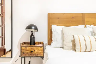 a bedroom with a bed and a lamp on a night stand at Urban Bliss Guesthouse I in Faro