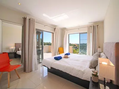 a bedroom with a bed and a large window at Apartment Pine Hills Diamante-12 by Interhome in Vilamoura