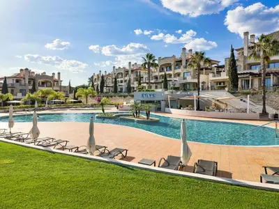 a swimming pool with lounge chairs and a resort at Apartment Pine Hills Diamante-12 by Interhome in Vilamoura