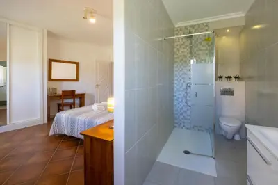 a bathroom with a bed and a shower with a toilet at Ma Vie La in Vale de Carros