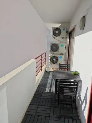 a room with a table and chairs on a balcony at Faro Stadium Flat by Freetimealgarve in Faro