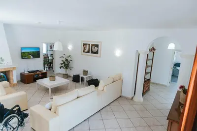 a living room with two couches and a fireplace at Villa Jorge by Ecovillas Albufeira in Galé