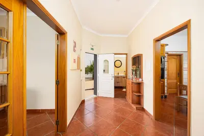 a living room with a couch and a fireplace at Villa Amendoeira in Albufeira