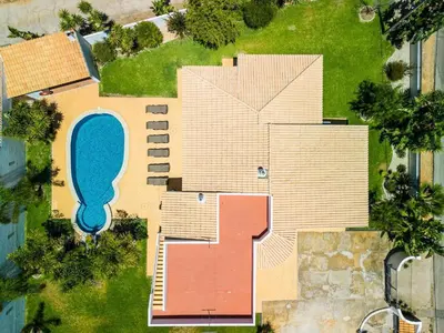 a bedroom with two beds and a desk and a window at Villa Amendoeira in Albufeira