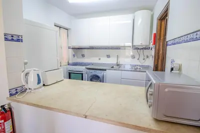 a kitchen with a sink and a counter top at Old Village- 2A Village Street in Quarteira