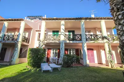 an exterior view of a building with a yard at Old Village- 2A Village Street in Quarteira