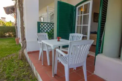 a white table and chairs on the porch of a house at Old Village- 1A Village Gate in Quarteira