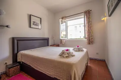 a bedroom with two stuffed animals on a bed at Old Village- 1A Village Gate in Quarteira