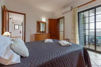 a bedroom with a bed with two pillows on it at Villa Ramos by Ecovillas Albufeira in Roja- Pé