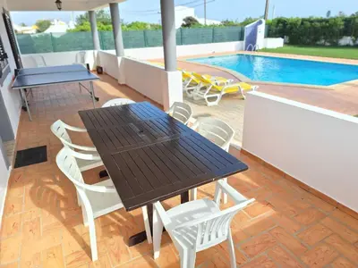 a living room with a couch and a chair at Villa Ramos by Ecovillas Albufeira in Roja- Pé