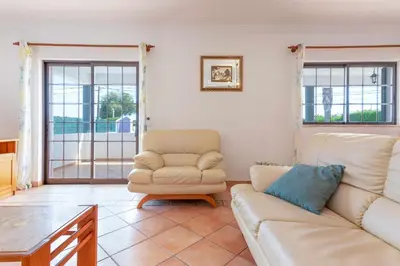 a patio with a table and chairs on a balcony at Villa Ramos by Ecovillas Albufeira in Roja- Pé