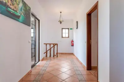 two beds with hats on top of them in a room at Villa Ramos by Ecovillas Albufeira in Roja- Pé