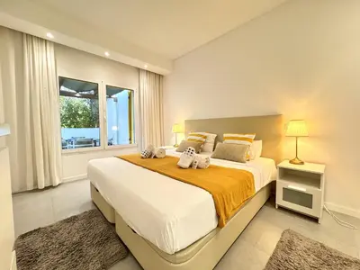 a bedroom with a large bed with two stuffed animals on it at Vilamoura Club Villa 1 With Pool by Homing in Vilamoura