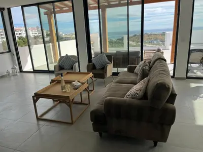 a living room with a couch and a coffee table at Ocean view by Charmes Penthouse in Albufeira