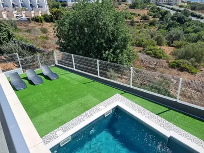 an image of a backyard with a swimming pool and grass at Ocean view by Charmes B in Albufeira