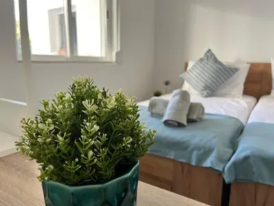 a room with a bed and a potted plant on a table at Ocean view by Charmes B in Albufeira