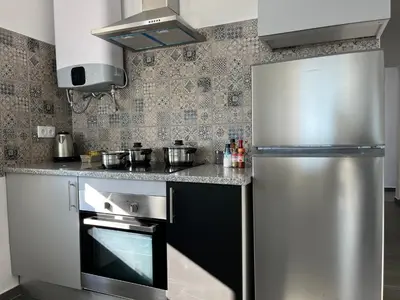 a kitchen with a stainless steel refrigerator and a stove at Ocean view by Charmes B in Albufeira