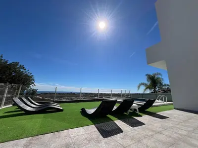 a group of chairs sitting on a lawn with a view of the ocean at Ocean view by Charmes B in Albufeira