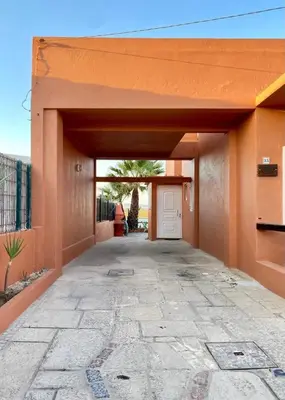 a garage with a white door in a building at Casa da Ria in Faro