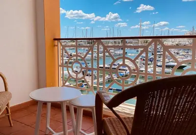 a balcony with a table and chairs and a view of a harbor at T1 Vista Marina de Vilamoura in Vilamoura
