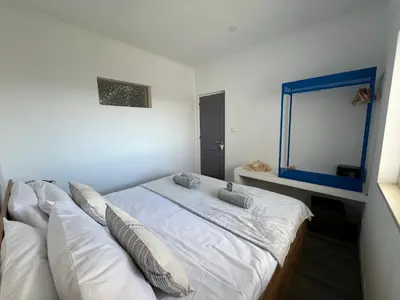 a bedroom with a bed with pillows and a mirror at Ocean view by Charmes C in Albufeira
