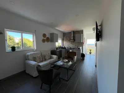 a living room with a couch and a table at Ocean view by Charmes C in Albufeira
