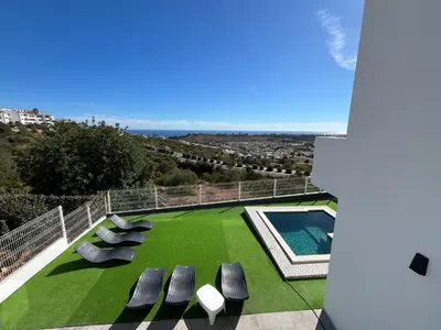 a balcony with chairs and a swimming pool at Ocean view by Charmes C in Albufeira