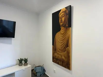 a large painting of a buddha on a wall at Ocean view by Charmes A in Albufeira