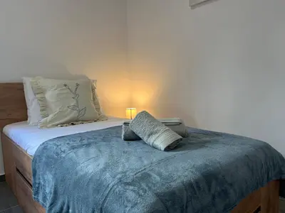 a bed with a blue blanket on top of it at Ocean view by Charmes A in Albufeira