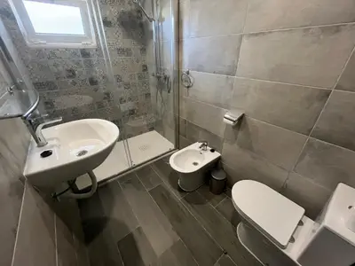 a bathroom with a sink and a toilet and a shower at Ocean view by Charmes A in Albufeira