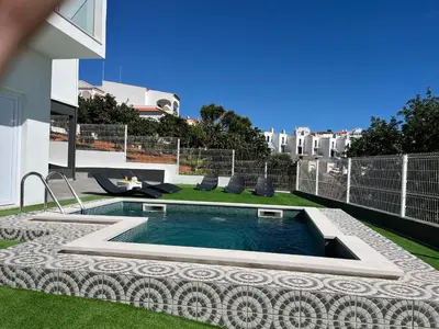 a swimming pool on the roof of a house at Ocean view by Charmes A in Albufeira
