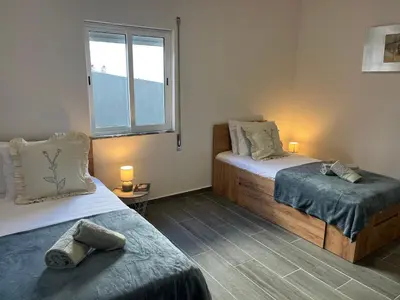 a bedroom with two beds and a window at Ocean view by Charmes A in Albufeira