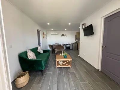 a living room with a green couch and a table at Ocean view by Charmes D in Albufeira