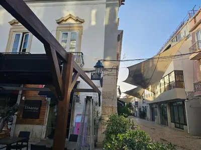 a building with an awning on a street at Blife Antonya private rooms at 3rd floor in Faro